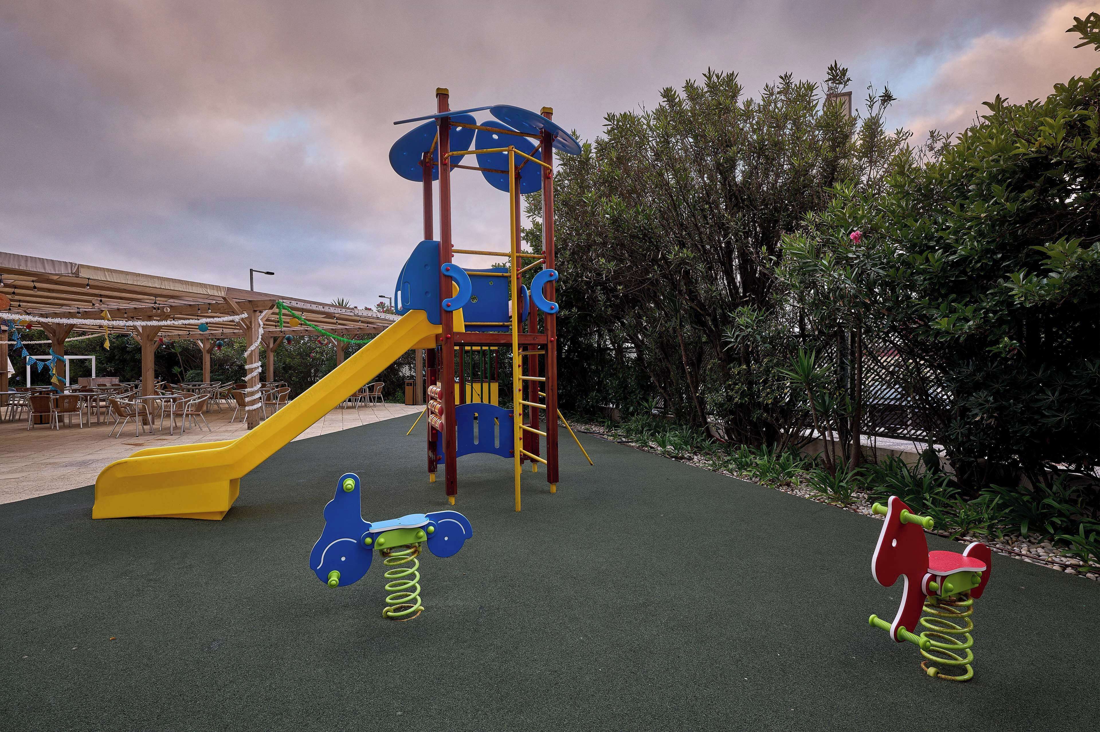 A playground with a slide, swings, and a climbing structure.