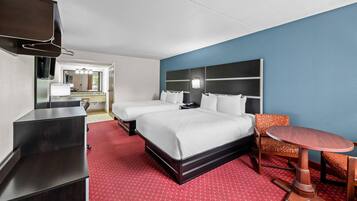 A hotel room with a bed, two bedside tables, a TV, a desk, and a chair.
