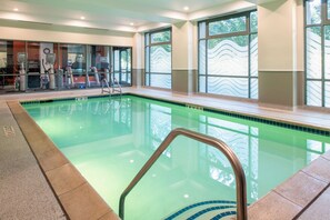 Swimmers can enjoy a refreshing dip in the rectangular pool surrounded by a tiled deck.