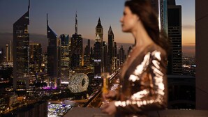 A cityscape with high-rise buildings and a clock tower, viewed from a balcony. - Fairmont Dubai (Dubai)