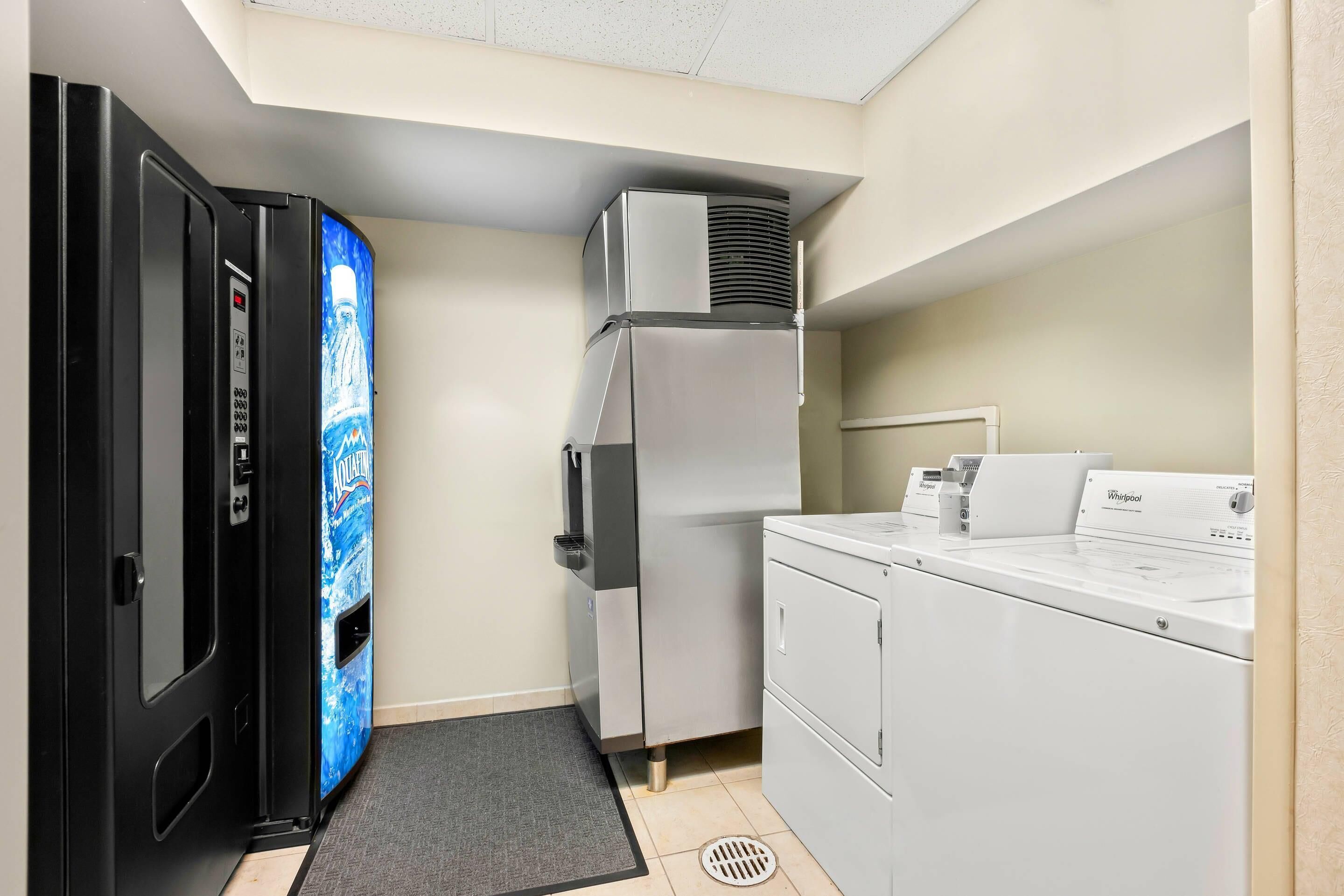 A compact laundry area with a refrigerator, a washer, and a dryer.