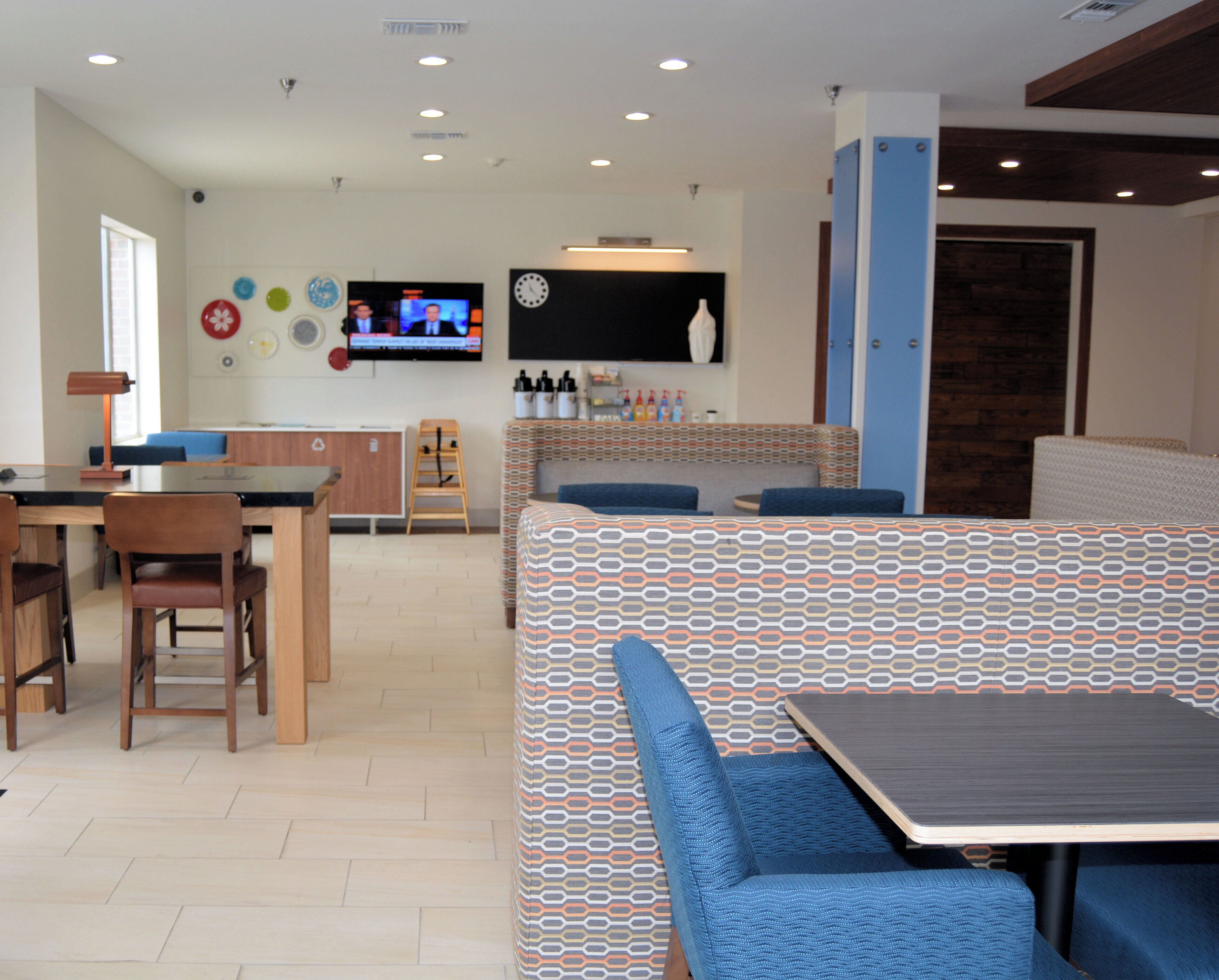 A modern interior with a dining area, kitchen, and seating.