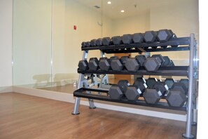 A gym with a rack of dumbbells and a mirror on the wall. - Holiday Inn Express & Suites by IHG (Abilene)