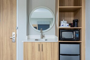 A compact kitchenette with a sink, a microwave, and a small refrigerator. - Hampton Inn & Suites Port St. Lucie, West (Port Saint Lucie)