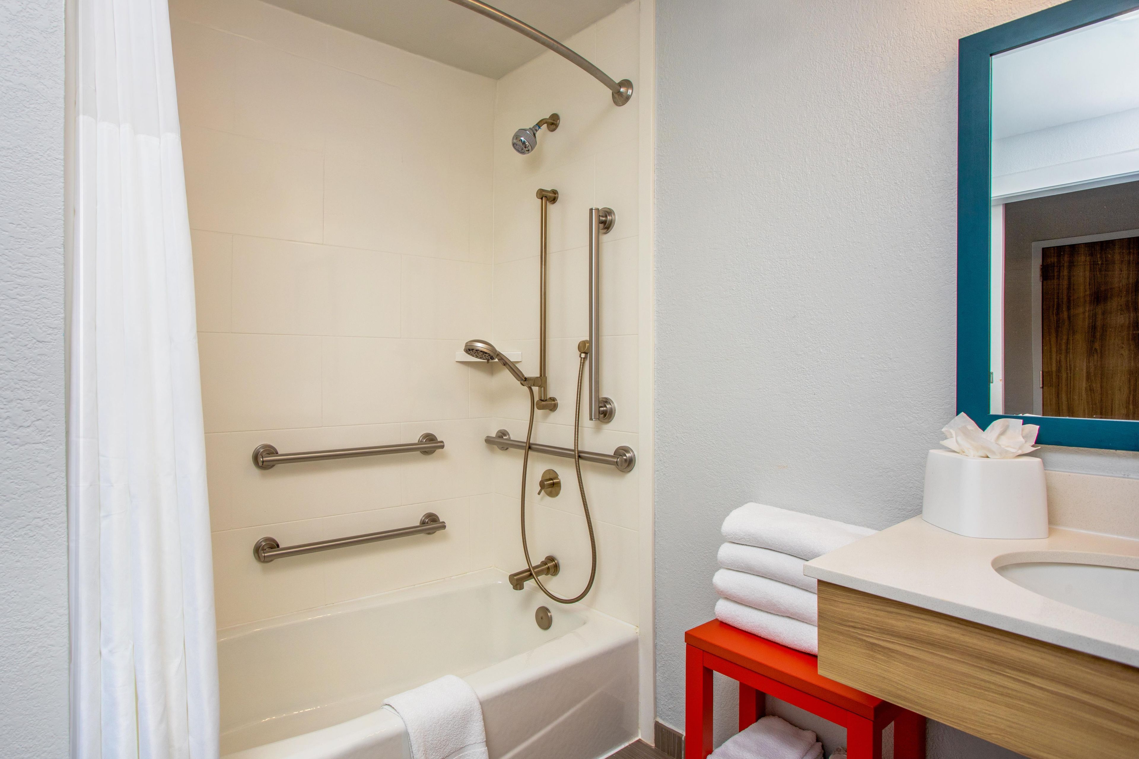 A bathroom with a bathtub, a shower, and a sink.