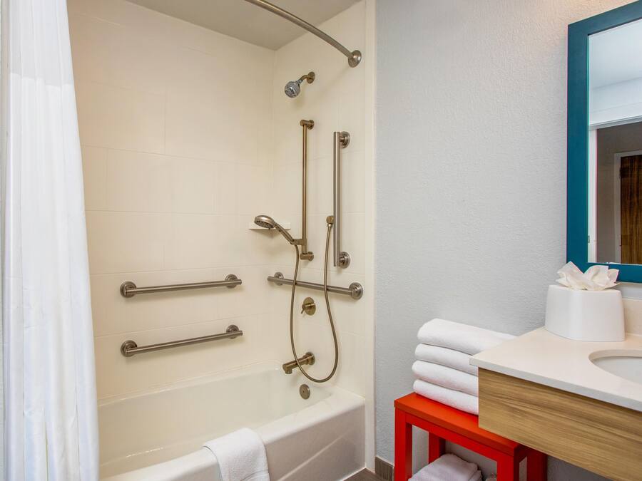 A bathroom with a bathtub, a shower, and a sink.