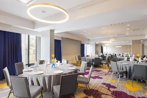 A hotel conference room with round tables, chairs, and a carpeted floor. - DoubleTree by Hilton Hotel Savannah Historic District (Savannah)