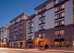 A multi-story hotel with a brick facade, large windows, and a flag. - DoubleTree by Hilton Hotel Savannah Historic District (Savannah)
