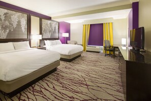 A hotel room with two beds, a desk, a TV, and a large window with curtains. - DoubleTree by Hilton Hotel Savannah Historic District (Savannah)