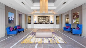 A spacious lobby with a central seating area, a reception desk, and a chandelier. - DoubleTree by Hilton Hotel Savannah Historic District (Savannah)