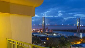 A view of a bridge at dusk with a building in the foreground.