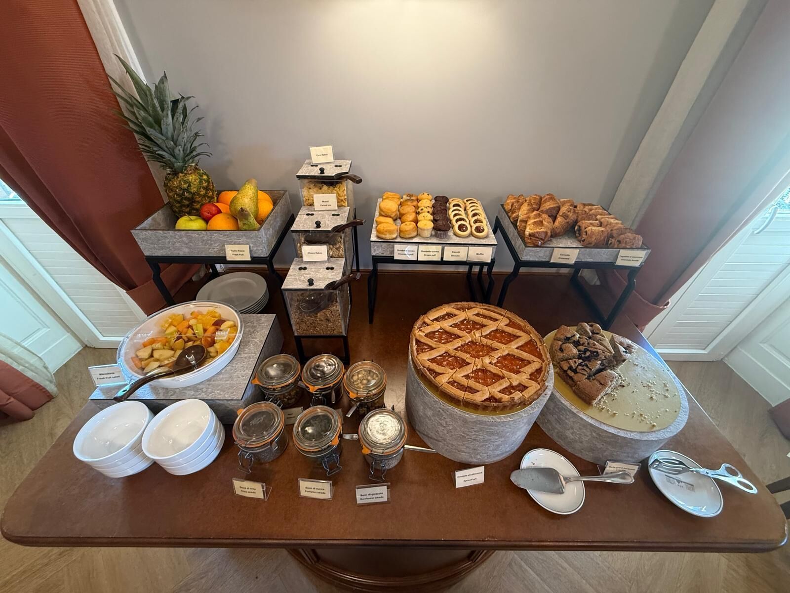 A buffet table with various food items and condiments.