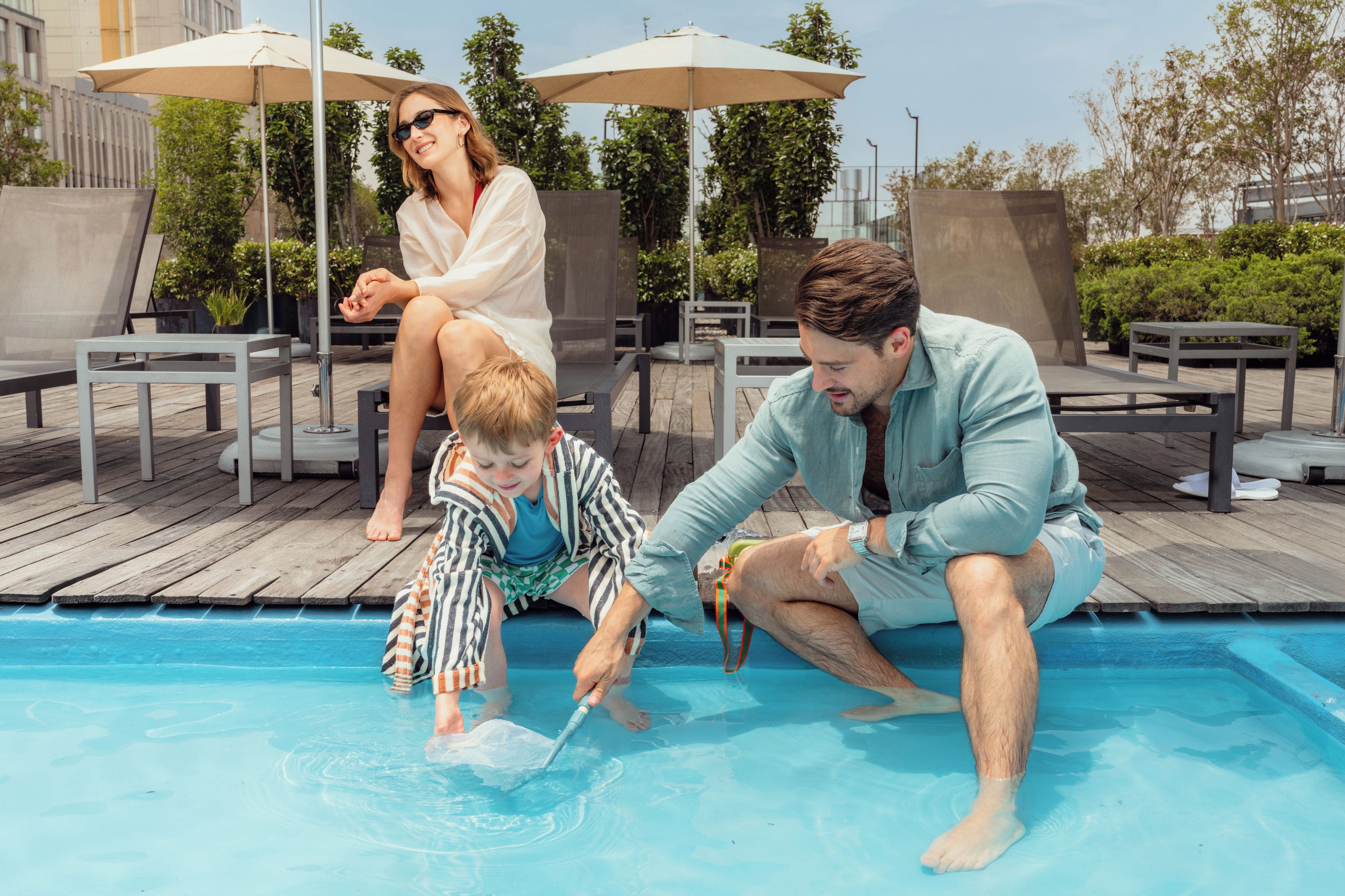 A poolside area with lounge chairs and umbrellas.