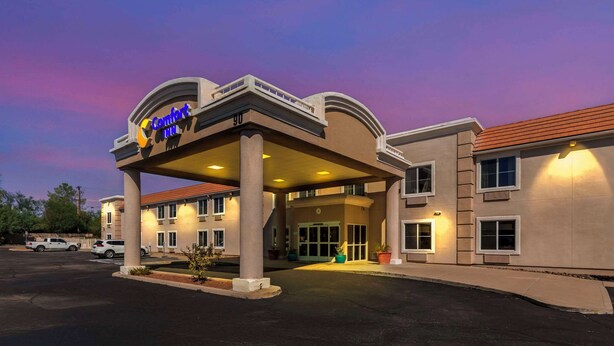 A Comfort Inn hotel with a covered entrance, multiple windows, and a parking lot.