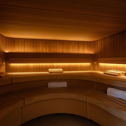 A sauna with wooden benches and benches, a bench with a towel, and a bench with a towel.