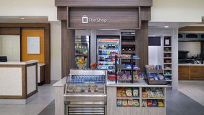 A shop with a variety of food items and beverages, including refrigerated sections and shelves stocked with snacks. - Hilton Garden Inn Houston/Bush Intercontinental Airport (Houston)