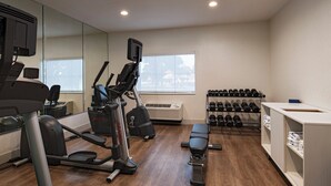 A gym with cardio machines, dumbbells, and a bench. - Holiday Inn Express Hotel & Suites Cedar Park by IHG (Cedar Park)