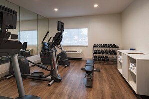 A gym with cardio machines, dumbbells, and a bench. - Holiday Inn Express Hotel & Suites Cedar Park by IHG (Cedar Park)