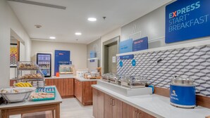 A breakfast area with a counter, food display, and a sign for Express Start Breakfast. - Holiday Inn Express Hotel & Suites Greenville by IHG (Greenville)