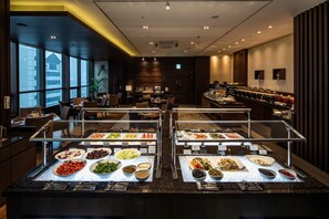 A buffet with various food items and a seating area with tables and chairs. - Oakwood Premier Coex Center (Seoul)