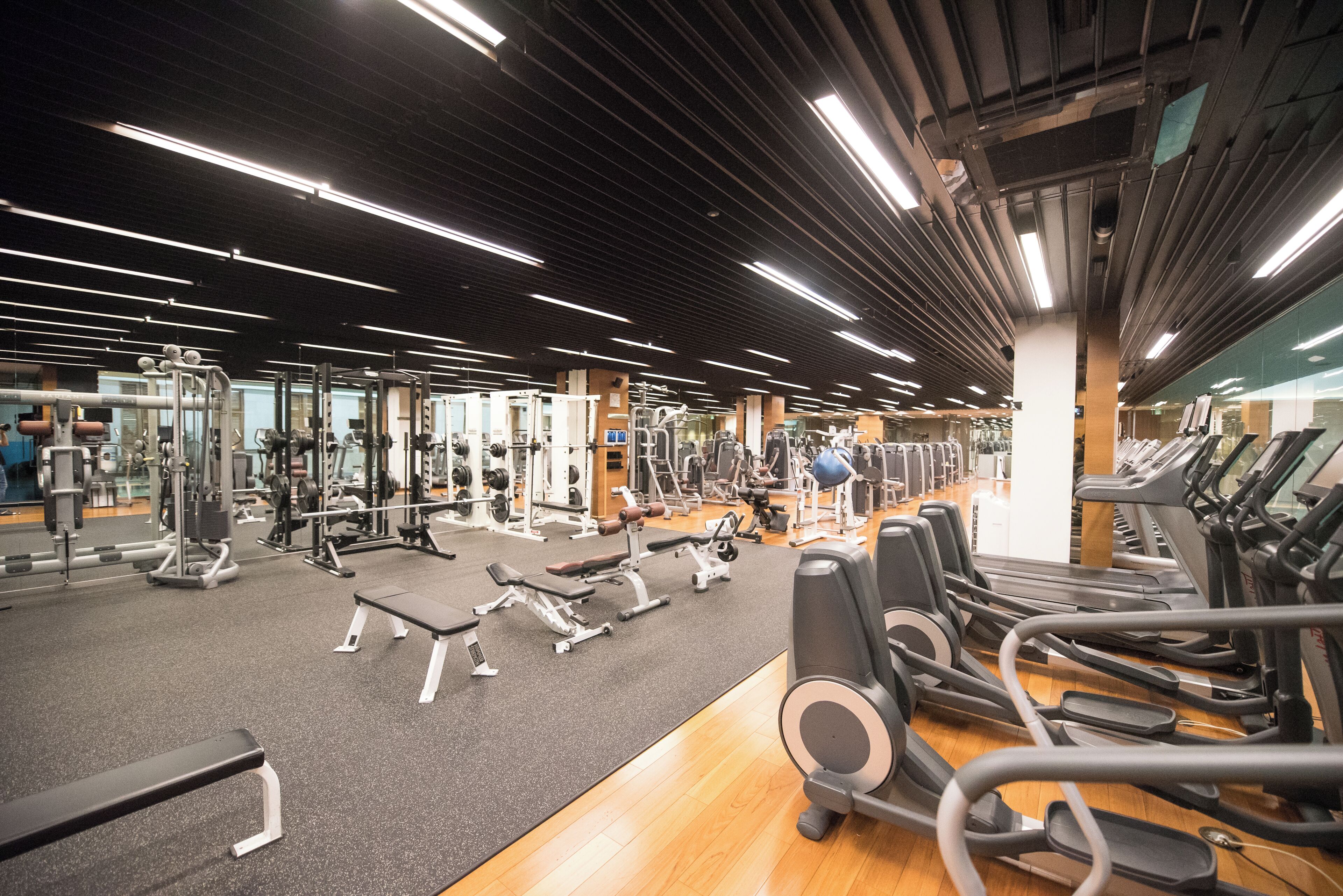 A gym with various exercise equipment, including treadmills and weight machines.