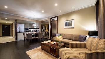 A modern living room with a sofa, coffee table, and dining area.