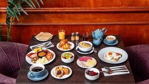 A breakfast table with various dishes, including toast, eggs, and fruit. - Mercure Daventry Court Hotel (Daventry)