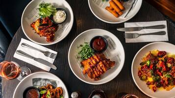 A table with various dishes, cutlery, and condiments.