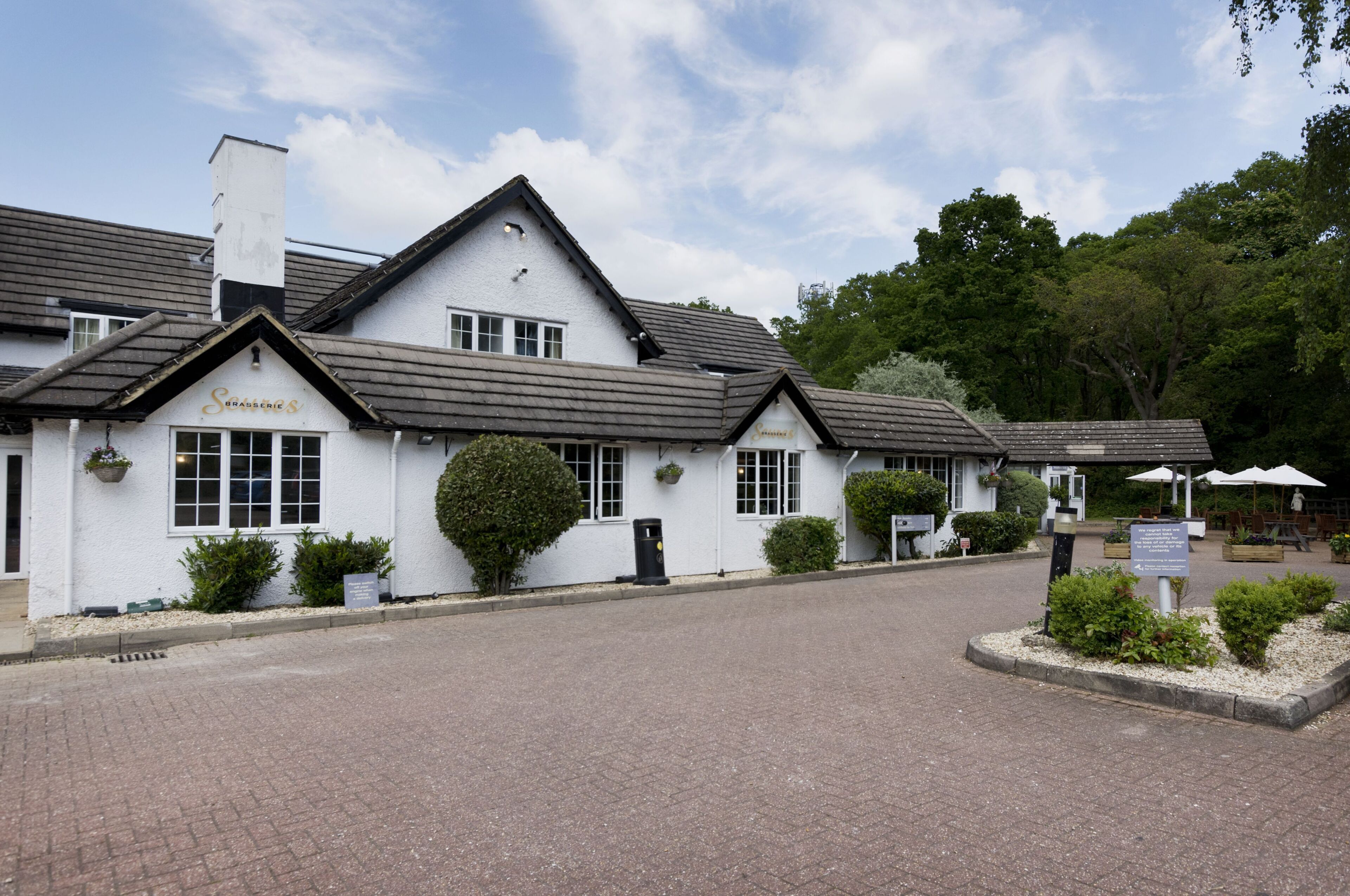 A white building with a sign reading 'Sofasches' and a paved entrance.