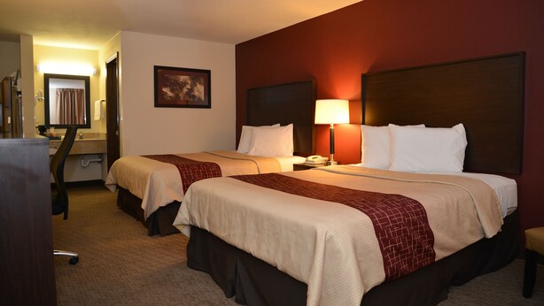 A hotel room with two beds, a desk, and a chair. - Red Roof Inn Cookeville - Tennessee Tech (Cookeville)