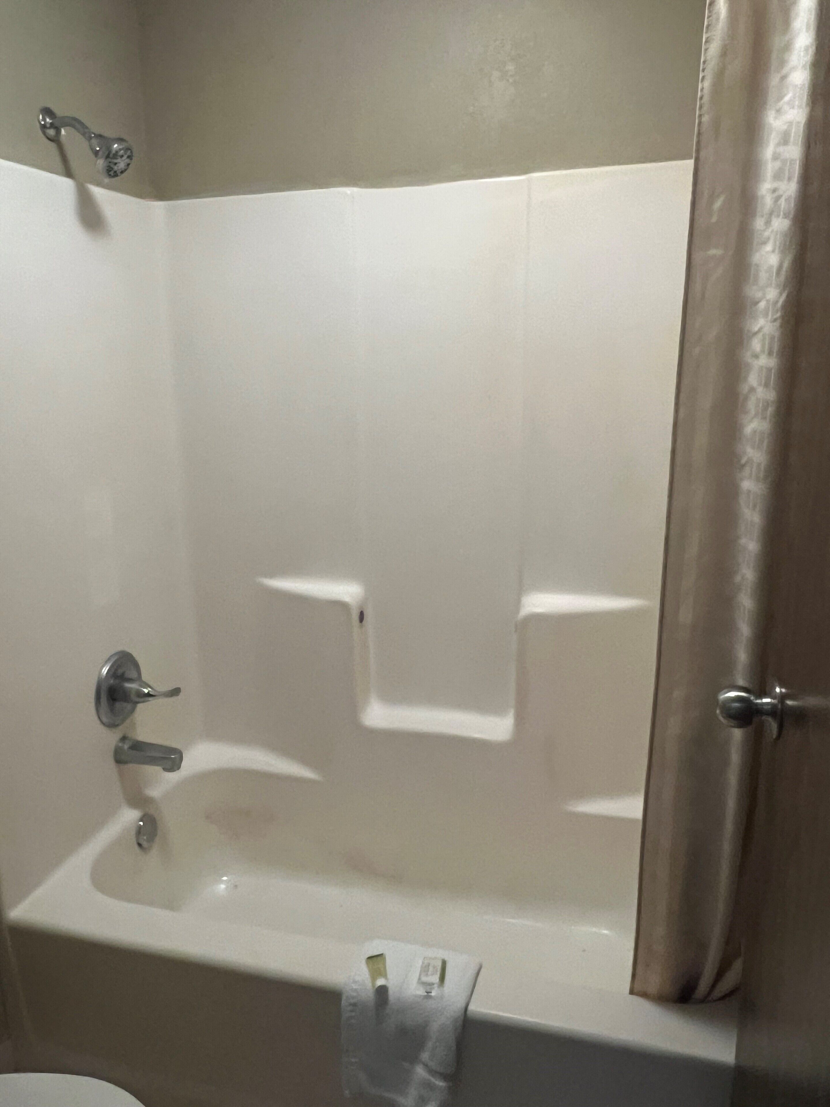 A bathroom with a bathtub, a shower, and a toilet.