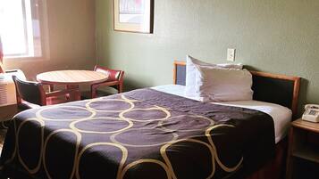 Premium bedding, desk, laptop workspace, blackout drapes