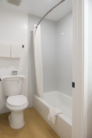 Room, 1 King Bed | Bathroom | Combined shower/tub, deep soaking tub, free toiletries, towels