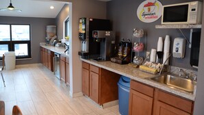 A modern kitchen with a refrigerator, microwave, coffee machine, and a Superstart Breakfast sign. - Super 8 by Wyndham Centerville (Centerville)