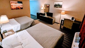 A hotel room with two beds, a desk with a computer, a TV, and a lamp. - Woodfield Inn and Suites (Marshfield)
