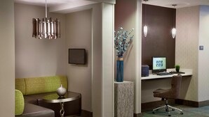 A modern hotel lobby with a seating area, a desk, and a computer. - Cambridge Suites Mississauga (Mississauga)