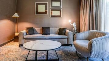 A modern living room with a sofa, armchair, and coffee table.