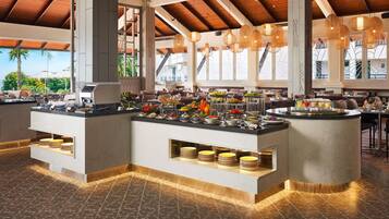 A buffet area with multiple serving stations, a variety of food items, and a modern interior design.