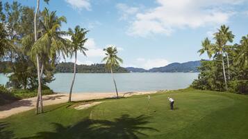 Enjoy a serene golfing experience with a picturesque view of the lake.