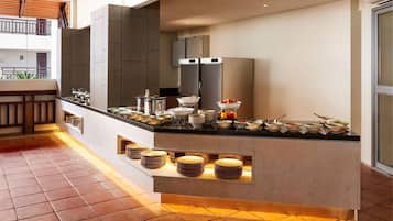A modern kitchen with a central island, built-in appliances, and a variety of dishes and utensils.