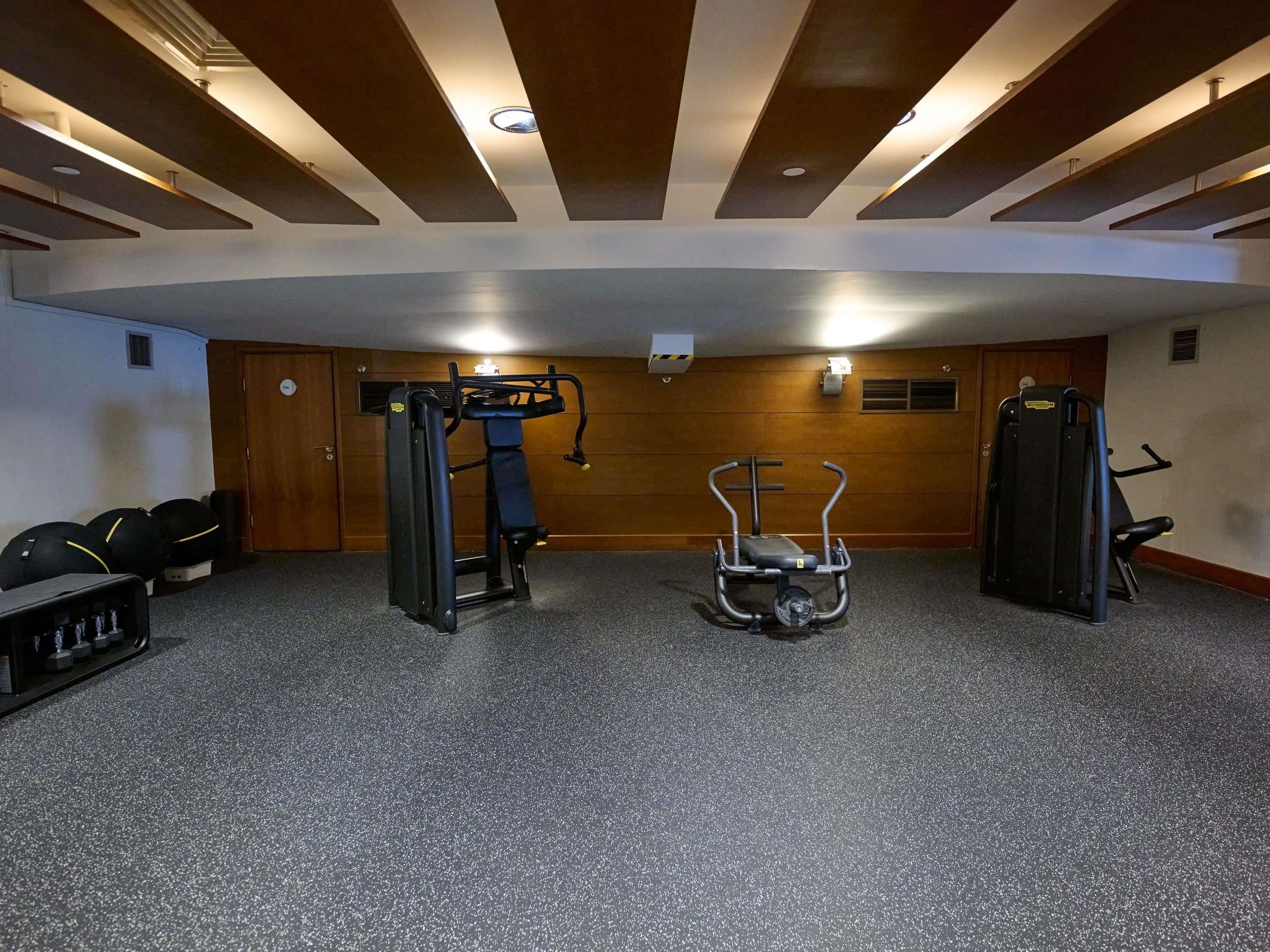 A gym with exercise equipment, a pull-up bar, and a stationary bike.
