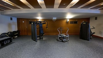 A gym with exercise equipment, a pull-up bar, and a stationary bike.