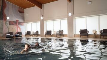 Relax by the pool surrounded by comfortable lounge chairs and sofas.