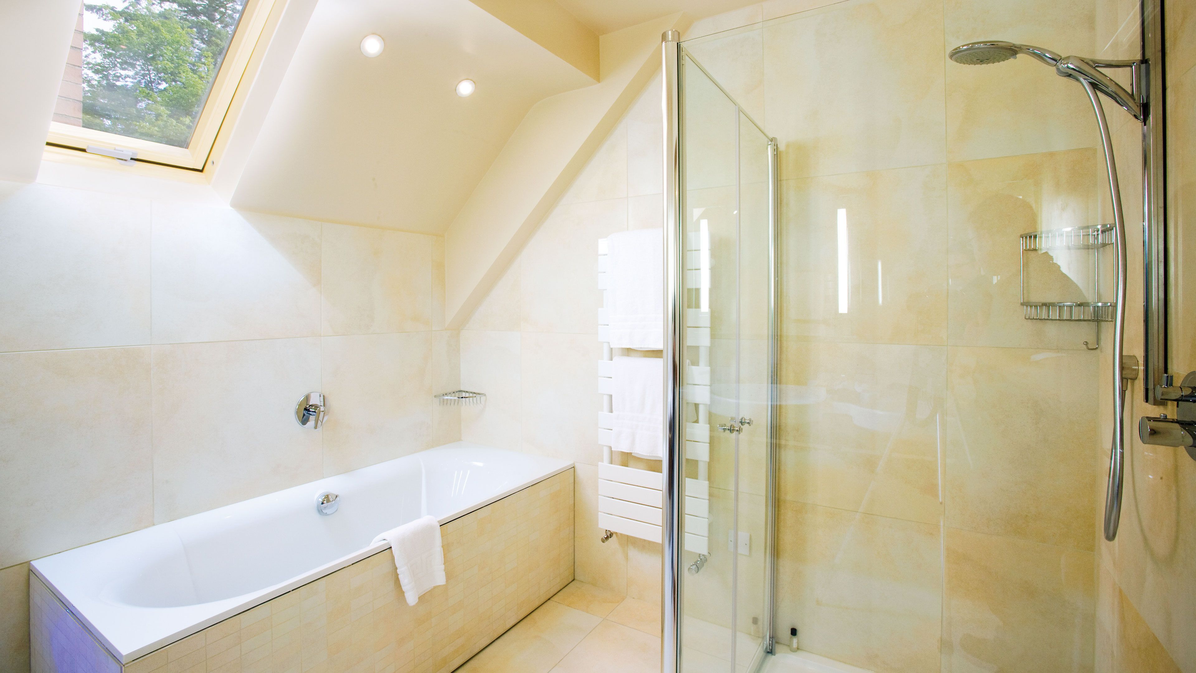 luxury studio suite | bathroom | shower, free toiletries, hair dryer, heated floors