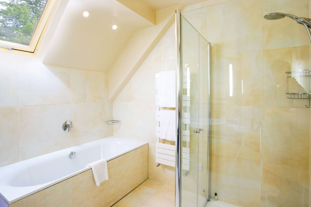 luxury studio suite | bathroom | shower, free toiletries, hair dryer, heated floors