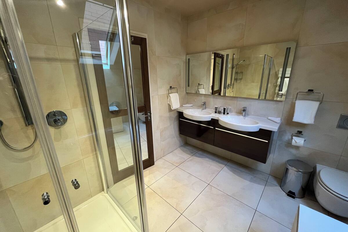 luxury studio suite | bathroom | shower, free toiletries, hair dryer, heated floors