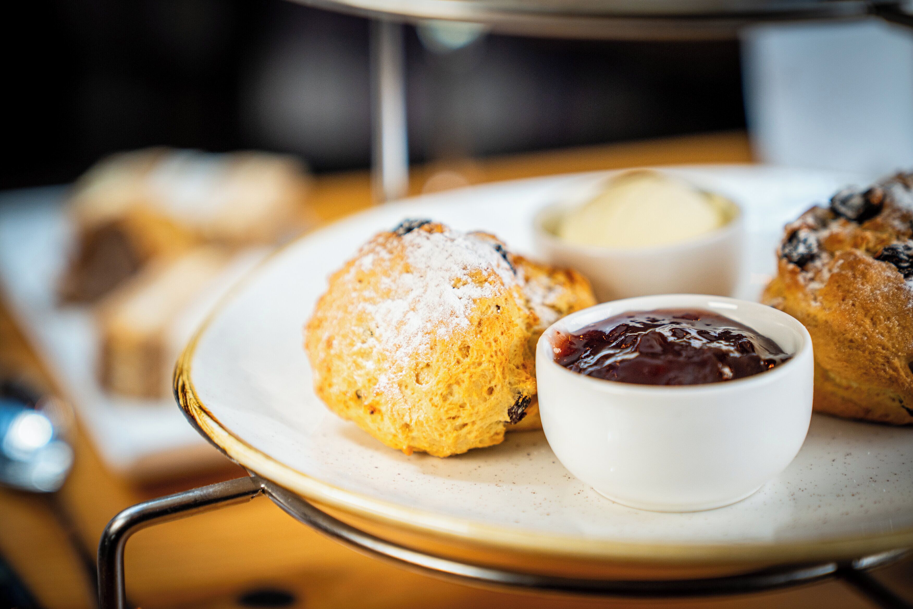 A tray with pastries and a small bowl of jam.