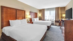 A hotel room with two beds, a desk, a television, and a window with curtains. - Comfort Inn Denver West Arvada Station (Wheat Ridge)