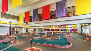 A miniature golf course with multiple holes, surrounded by brick walls and green turf. - Quality Inn Roseville-Detroit North (Roseville)