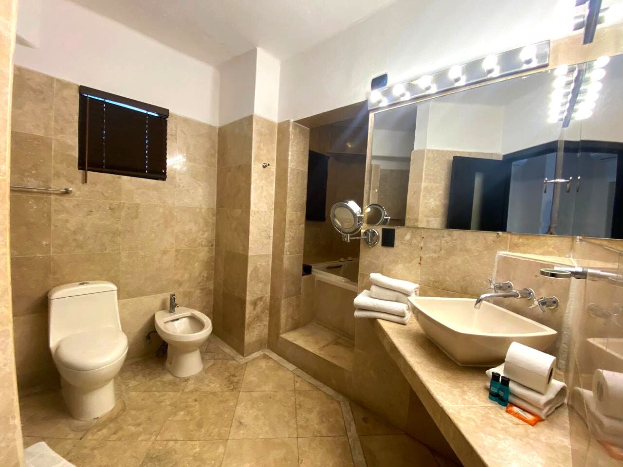 deluxe room | bathroom | shower, rainfall showerhead, free toiletries, hair dryer